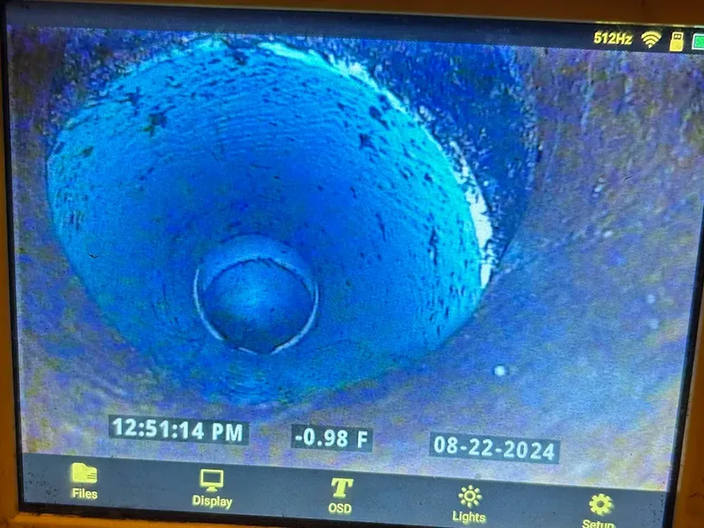 Sewer inspection camera screen showing the inside of a drain line